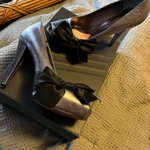 Size 7.5 silver heels, with black bow on front peep toe. Worn once.